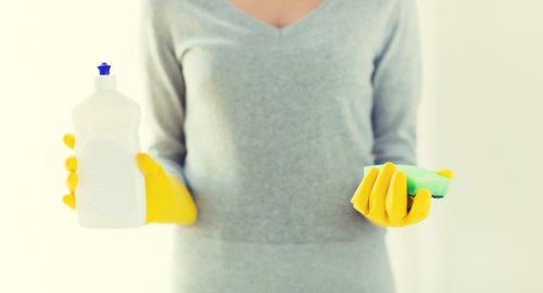 Cleaner treating a carpet stain in a SE15 home interior